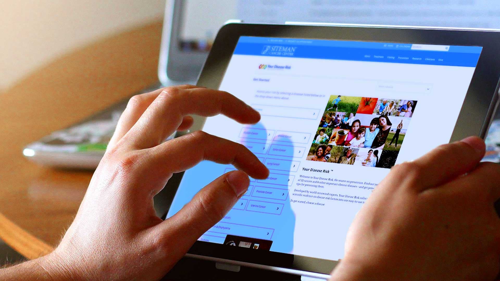 A hand scrolling a website on a tablet